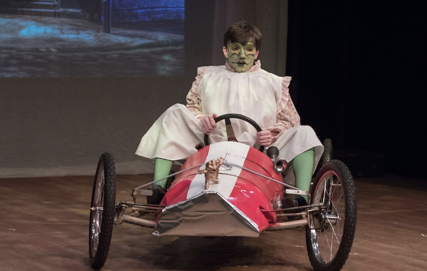 boy on toy car