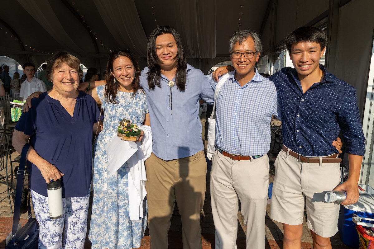 Student standing with family