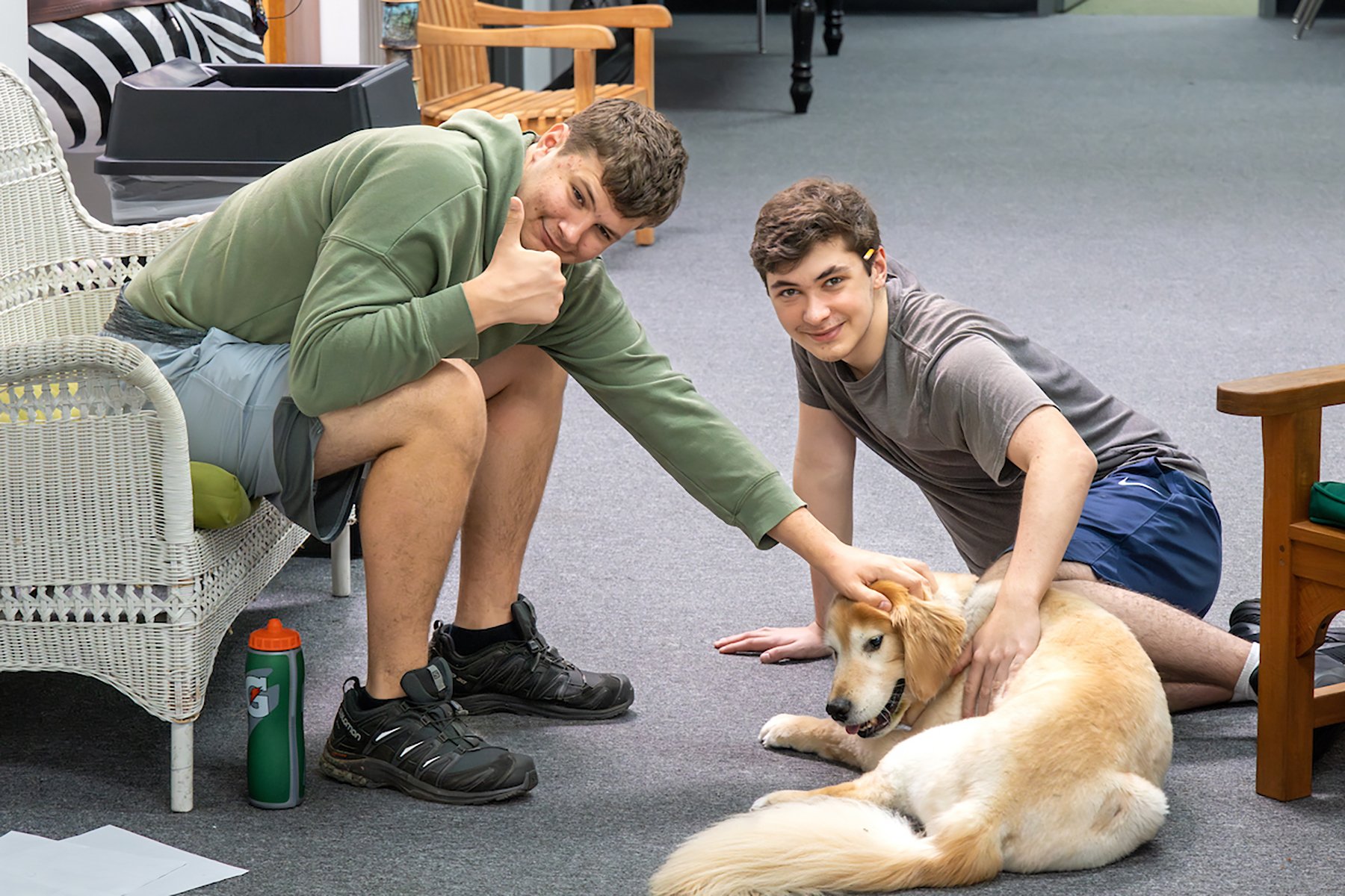 2 students petting a dog