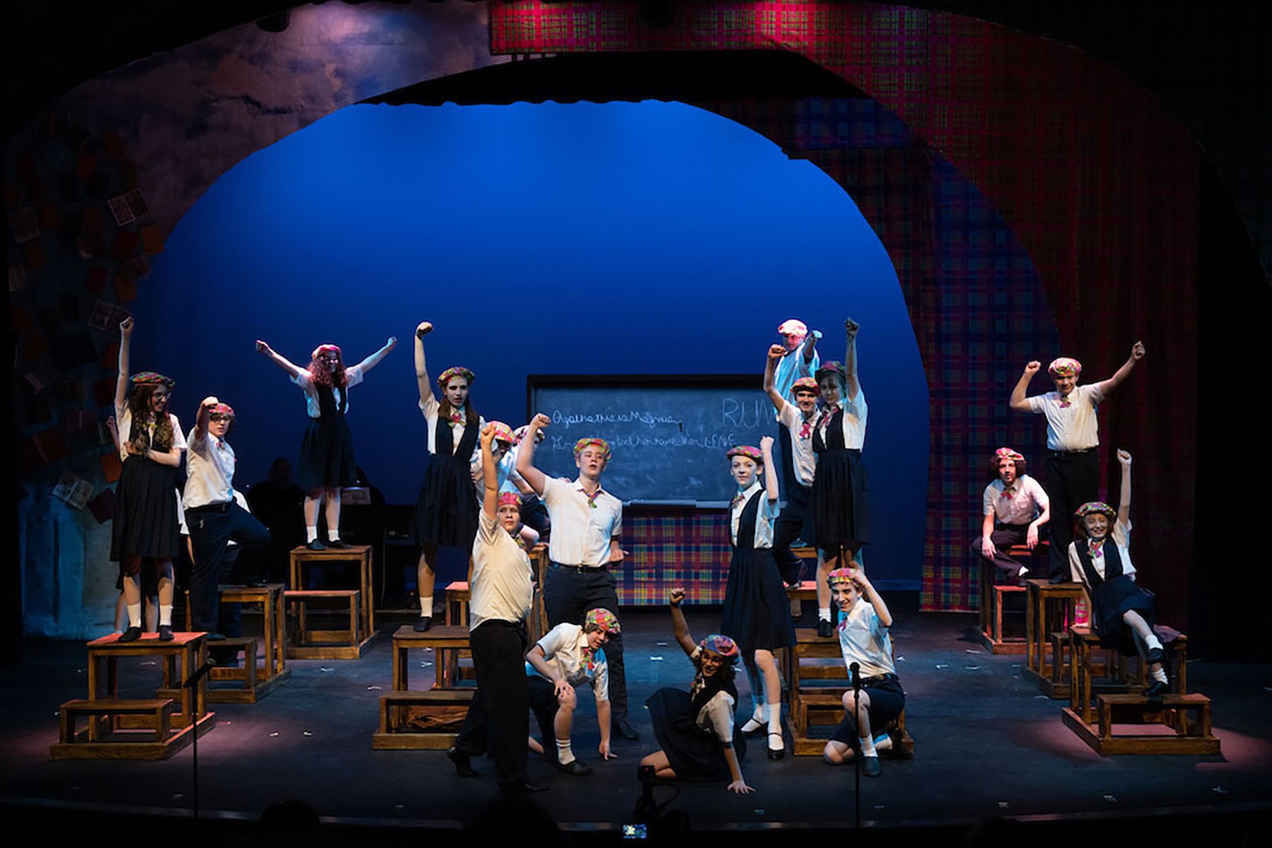 students performing on stage