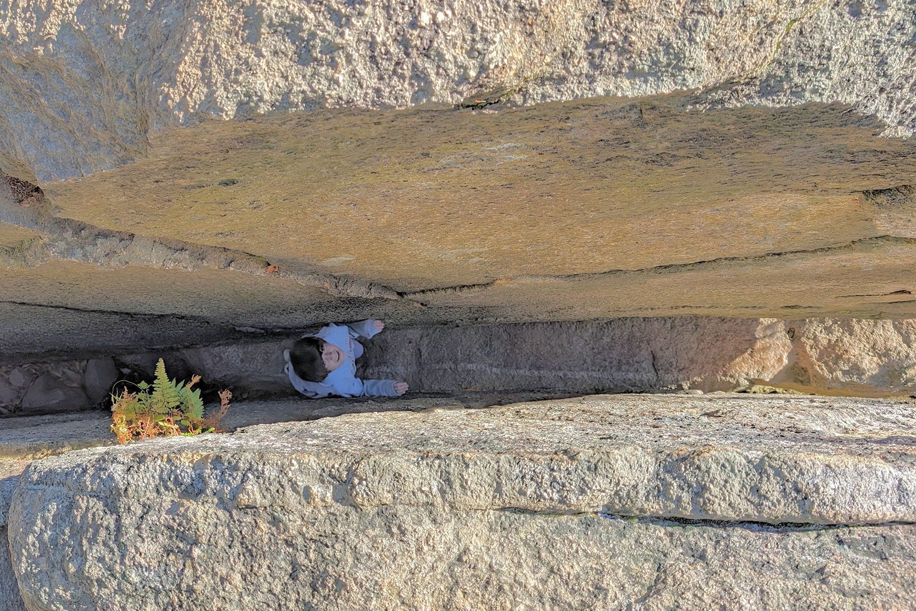 student between 2 large rocks