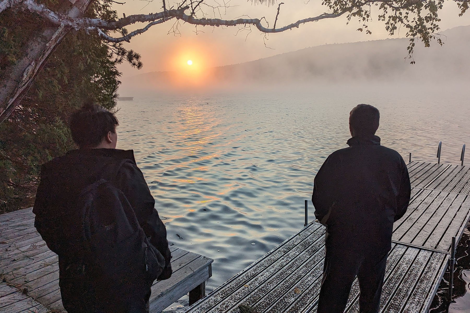 2 students on pier overlooking Silver Lake at sunset