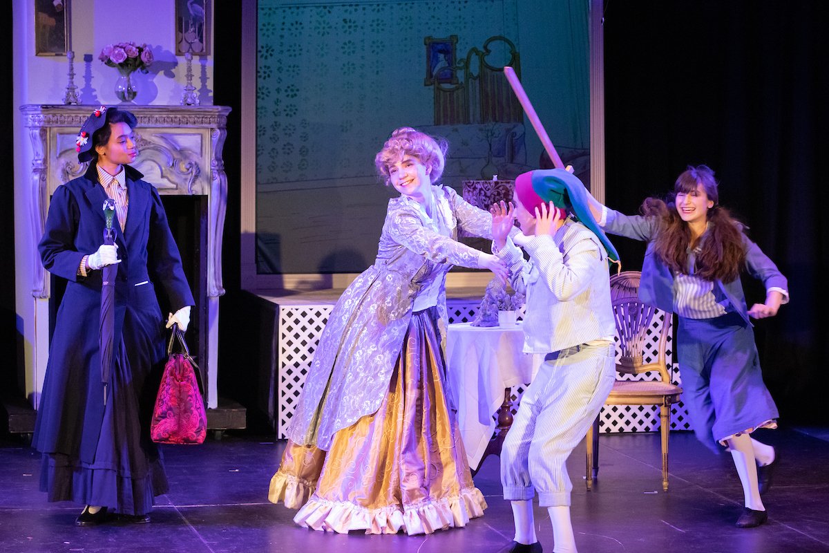 Students playing Mary Poppins watching the children running on stage 